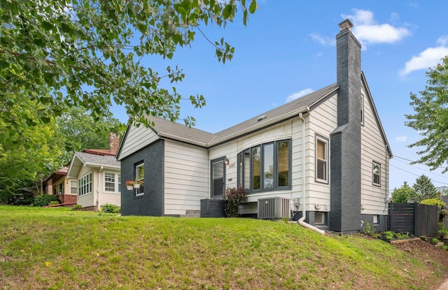 5257 27th Ave S, Minneapolis, MN 55417 - view of front of home with cooling unit and a chimney