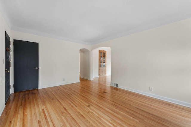 5257 27th Ave S, Minneapolis, MN 55417 - empty room with arched walkways, light wood-style flooring, and baseboards