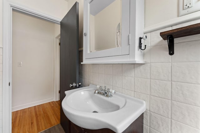 5257 27th Ave S, Minneapolis, MN 55417 - bathroom featuring tasteful backsplash, wood finished floors, baseboards, and a sink