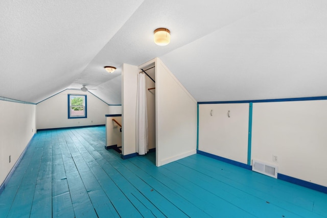 5257 27th Ave S, Minneapolis, MN 55417 - additional living space with baseboards, lofted ceiling, wood finished floors, and a textured ceiling