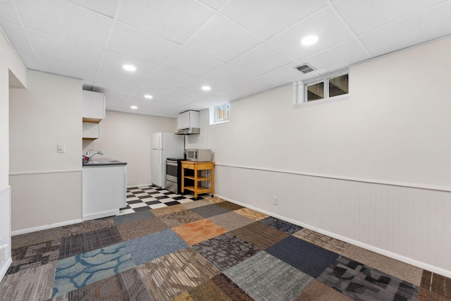 5257 27th Ave S, Minneapolis, MN 55417 - basement featuring a sink, wainscoting, a drop ceiling, freestanding refrigerator, and recessed lighting