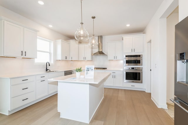 9887 49th St NE, Saint Michael, MN 55376 - kitchen with wall chimney exhaust hood, a sink, appliances with stainless steel finishes, light countertops, and white cabinetry
