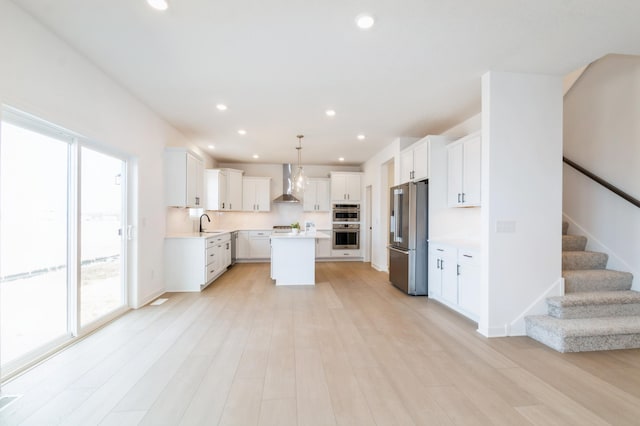 9887 49th St NE, Saint Michael, MN 55376 - kitchen featuring appliances with stainless steel finishes, wall chimney range hood, healthy amount of natural light, a sink, and recessed lighting