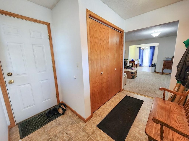 509 Clyde St, West Concord, MN 55985 - foyer featuring baseboards, a chandelier, and light tile patterned flooring
