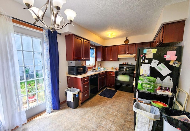 509 Clyde St, West Concord, MN 55985 - kitchen featuring black appliances, under cabinet range hood, a chandelier, light countertops, and a textured ceiling