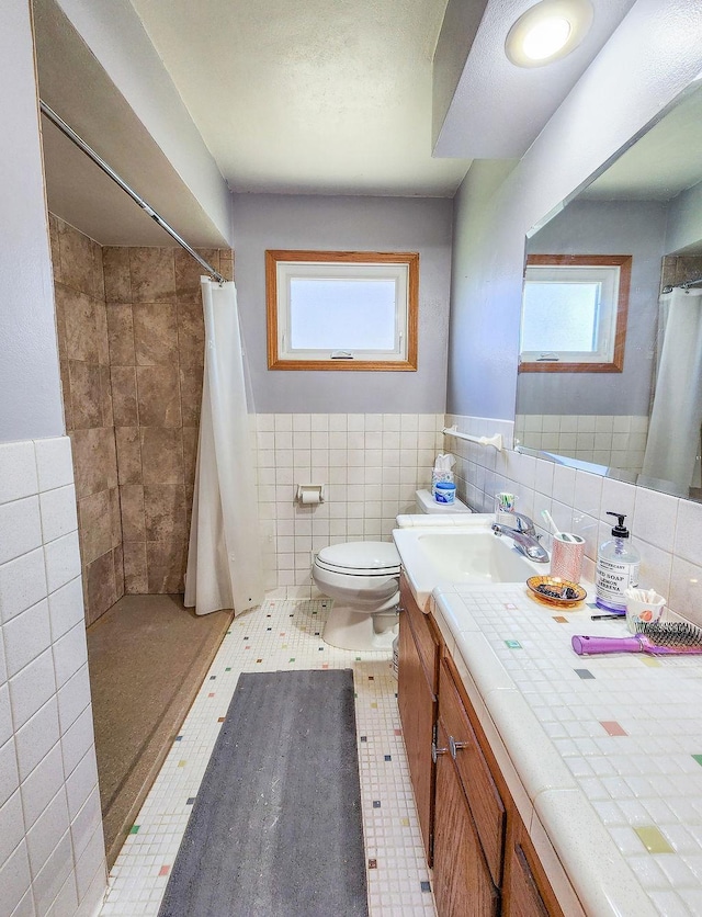 509 Clyde St, West Concord, MN 55985 - bathroom with tile walls, vanity, plenty of natural light, toilet, and tiled shower