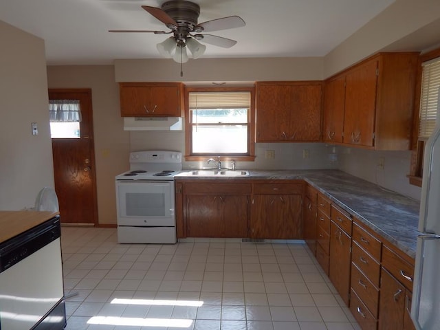 1052 36th Ave N, Saint Cloud, MN 56303 - kitchen with white appliances, a sink, under cabinet range hood, brown cabinets, and plenty of natural light