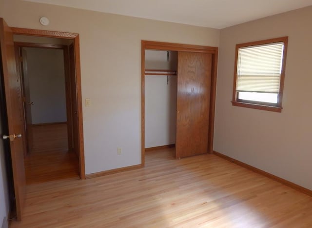 1052 36th Ave N, Saint Cloud, MN 56303 - unfurnished bedroom with light wood-style floors, a closet, and baseboards