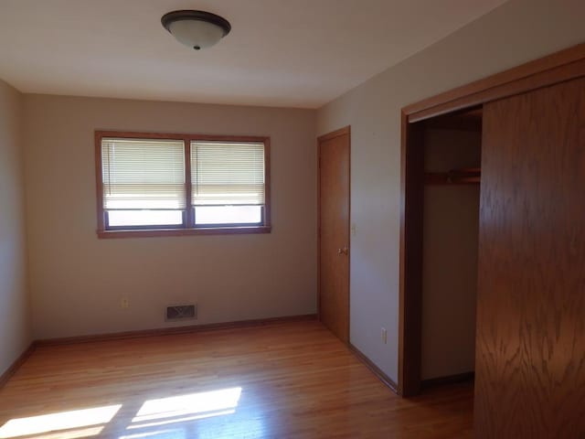 1052 36th Ave N, Saint Cloud, MN 56303 - unfurnished bedroom featuring light wood-type flooring and baseboards