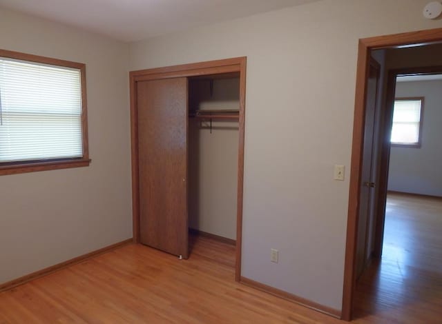 1052 36th Ave N, Saint Cloud, MN 56303 - unfurnished bedroom with light wood-style floors, a closet, and baseboards