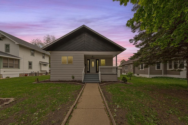 2939 Linden Ave, Slayton, MN 56172 - bungalow-style home with covered porch and a front lawn