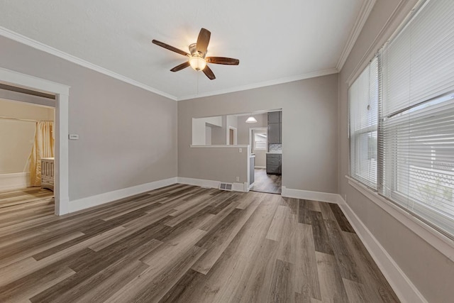 2939 Linden Ave, Slayton, MN 56172 - unfurnished room featuring ceiling fan, dark wood-style flooring, baseboards, and ornamental molding