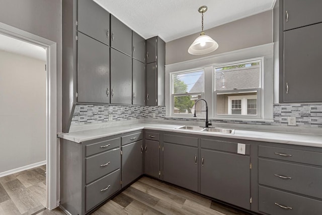 2939 Linden Ave, Slayton, MN 56172 - kitchen featuring a sink, gray cabinetry, and tasteful backsplash