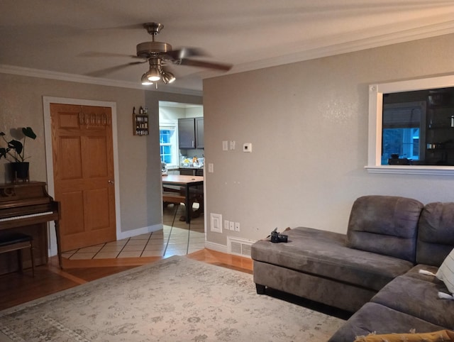232 2nd St NW, Menahga, MN 56464 - living room featuring ornamental molding, a ceiling fan, and light wood-style floors