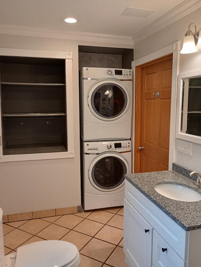 232 2nd St NW, Menahga, MN 56464 - washroom with stacked washing machine and dryer, ornamental molding, and light tile patterned floors