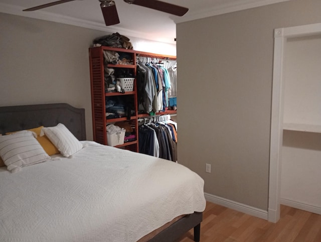 232 2nd St NW, Menahga, MN 56464 - bedroom with light wood finished floors, crown molding, ceiling fan, and a closet