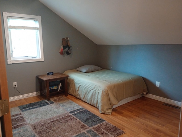 232 2nd St NW, Menahga, MN 56464 - bedroom featuring lofted ceiling and wood finished floors