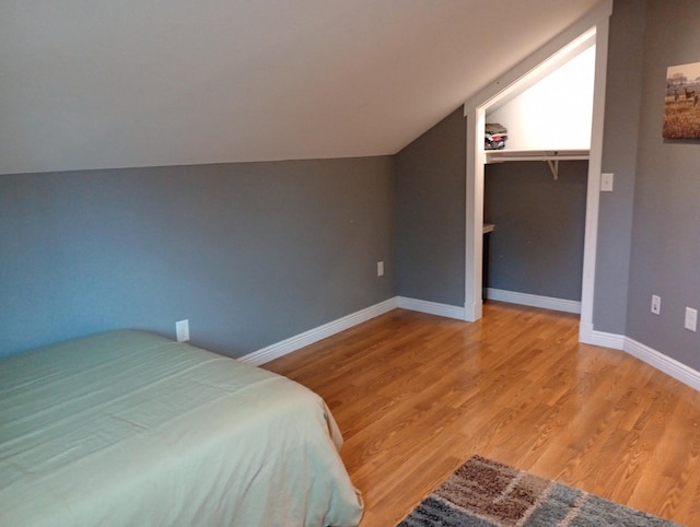 232 2nd St NW, Menahga, MN 56464 - bedroom featuring lofted ceiling and wood finished floors