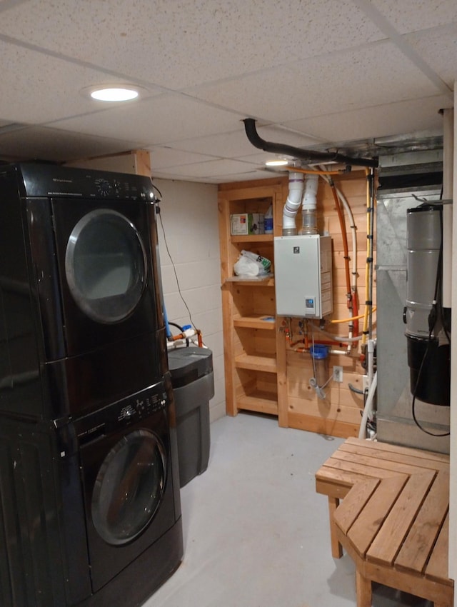 232 2nd St NW, Menahga, MN 56464 - laundry room with stacked washer and clothes dryer, tankless water heater, and concrete block wall