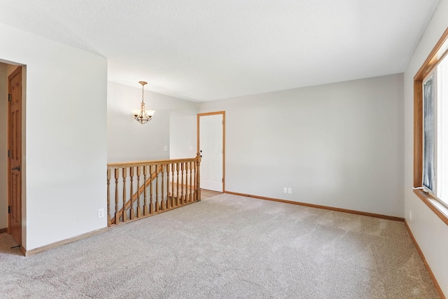 11001 Quincy Blvd NE, Blaine, MN 55434 - carpeted empty room featuring a chandelier, healthy amount of natural light, and baseboards