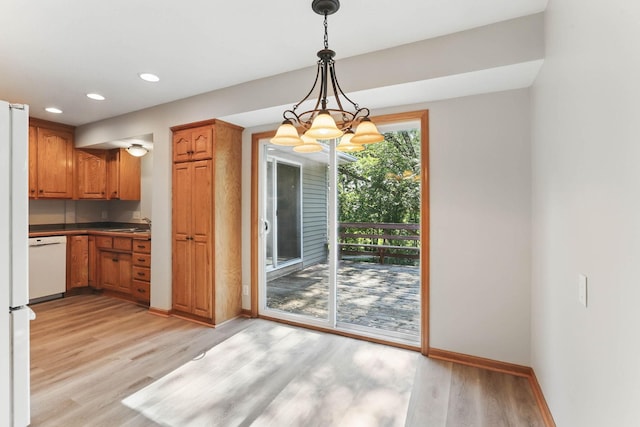 11001 Quincy Blvd NE, Blaine, MN 55434 - unfurnished dining area featuring light wood-style flooring, recessed lighting, baseboards, a chandelier, and a sink