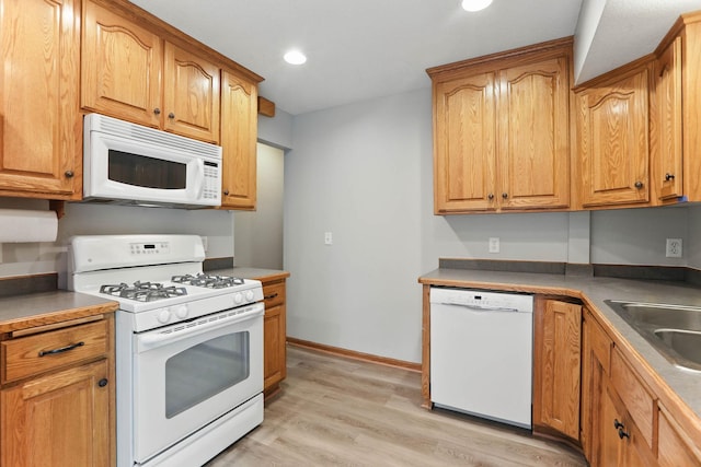 11001 Quincy Blvd NE, Blaine, MN 55434 - kitchen with white appliances, light wood-style floors, recessed lighting, a sink, and baseboards