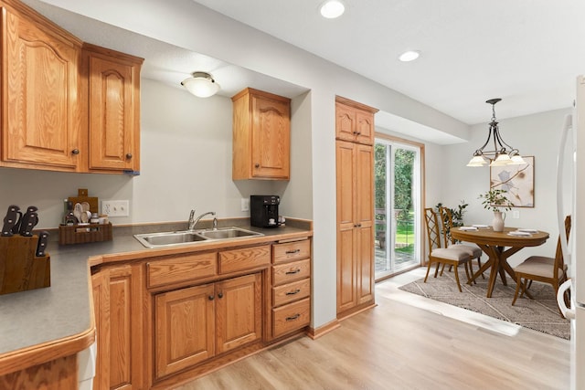 11001 Quincy Blvd NE, Blaine, MN 55434 - kitchen featuring a sink, light wood finished floors, hanging light fixtures, recessed lighting, and brown cabinets