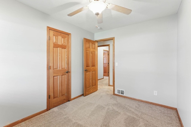 11001 Quincy Blvd NE, Blaine, MN 55434 - unfurnished bedroom with light carpet, baseboards, and ceiling fan