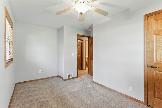 11001 Quincy Blvd NE, Blaine, MN 55434 - unfurnished bedroom featuring light carpet, baseboards, and ceiling fan