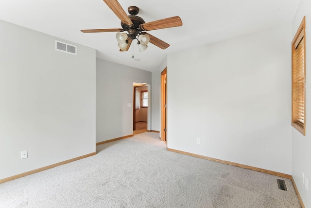 11001 Quincy Blvd NE, Blaine, MN 55434 - spare room with light colored carpet, ceiling fan, and baseboards