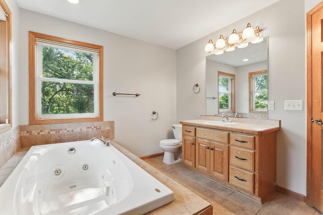 11001 Quincy Blvd NE, Blaine, MN 55434 - full bath featuring vanity, a tub with jets, toilet, and tile patterned flooring