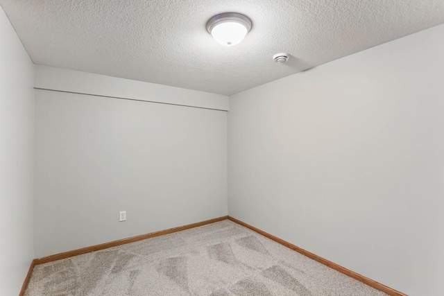 11001 Quincy Blvd NE, Blaine, MN 55434 - carpeted empty room with baseboards, a smoke detector, and a textured ceiling
