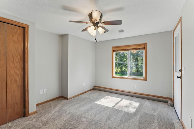11001 Quincy Blvd NE, Blaine, MN 55434 - unfurnished bedroom with light colored carpet, baseboards, and ceiling fan
