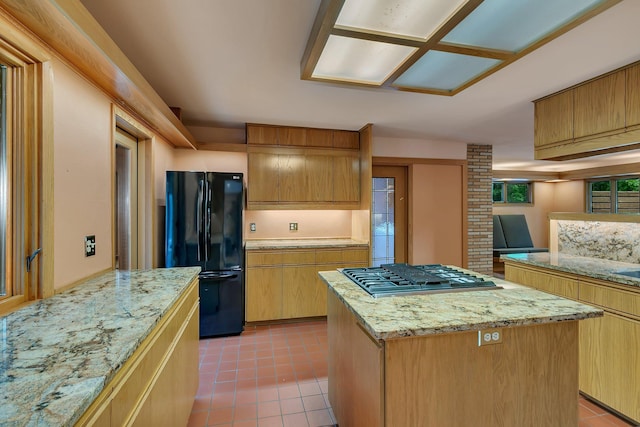 398 Riverside Ave S, Sartell, MN 56377 - kitchen with freestanding refrigerator, stainless steel gas stovetop, light tile patterned flooring, and a kitchen island