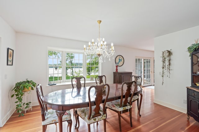8821 Interlachen Rd, Lake Shore, MN 56468 - dining area featuring a chandelier, light wood finished floors, and a water view
