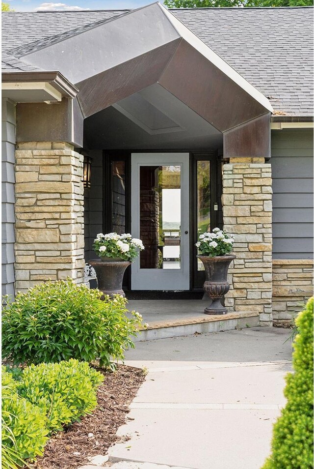 3850 Lone Cedar Ln, Chanhassen, MN 55318 - doorway to property featuring stone siding and roof with shingles