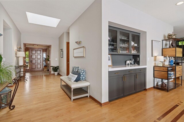 3850 Lone Cedar Ln, Chanhassen, MN 55318 - bar with a skylight and light wood-type flooring