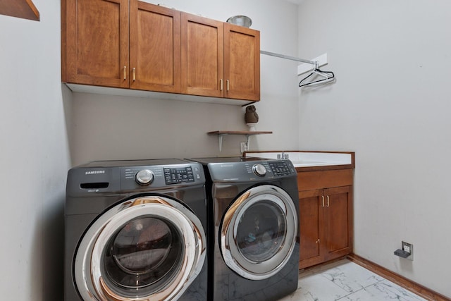 3850 Lone Cedar Ln, Chanhassen, MN 55318 - laundry room featuring cabinet space, washing machine and dryer, light marble finish flooring, and baseboards