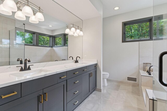 3850 Lone Cedar Ln, Chanhassen, MN 55318 - full bathroom with healthy amount of natural light, double vanity, toilet, a bathtub, and recessed lighting
