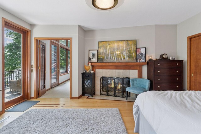 3850 Lone Cedar Ln, Chanhassen, MN 55318 - bedroom with wood finished floors, access to outside, and multiple windows
