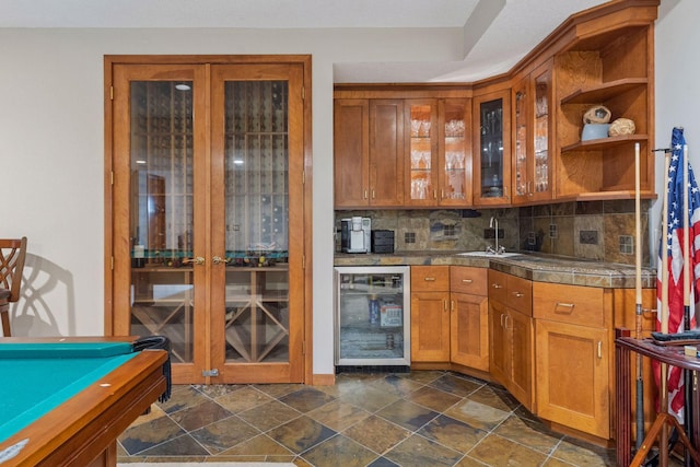 3850 Lone Cedar Ln, Chanhassen, MN 55318 - indoor wet bar featuring wine cooler, decorative backsplash, and dark stone finish floors