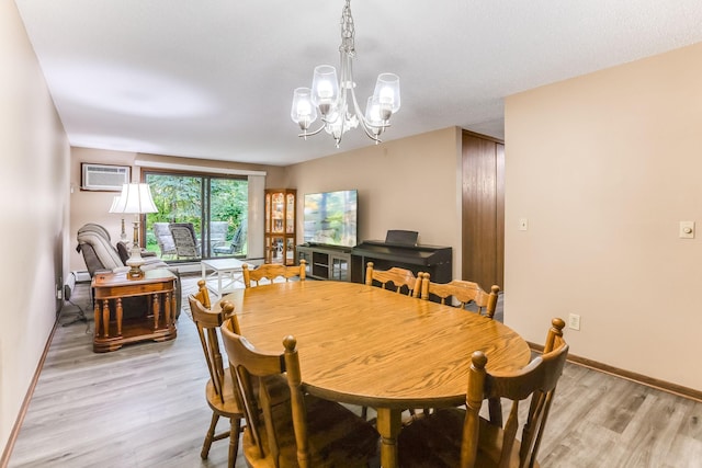 1855 Silver Bell Rd Unit 120, Eagan, MN 55122 - dining area featuring a chandelier, light wood-style flooring, and an AC wall unit