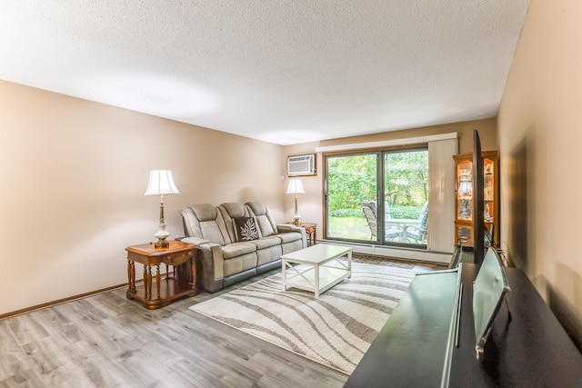 1855 Silver Bell Rd Unit 120, Eagan, MN 55122 - living area featuring wood finished floors, a textured ceiling, and a wall unit AC