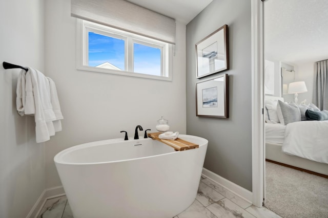 2740 Aspen Dr, Shakopee, MN 55379 - ensuite bathroom featuring marble finish floors, a soaking tub, and baseboards