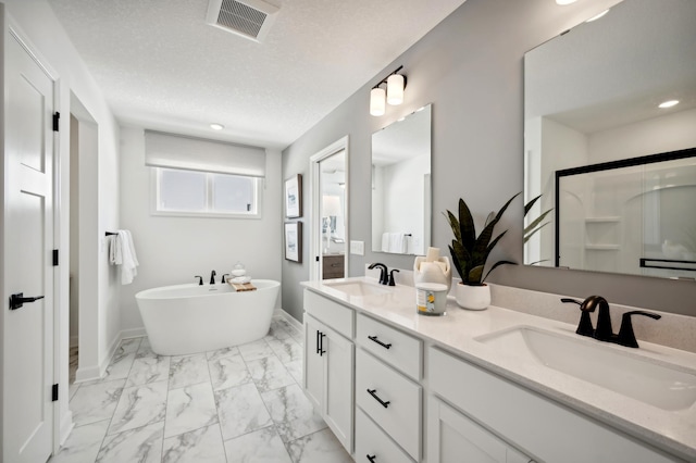 2740 Aspen Dr, Shakopee, MN 55379 - bathroom featuring marble finish flooring, double vanity, a freestanding bath, a shower stall, and baseboards