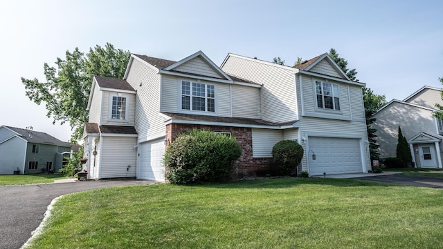 15608 Fjord Ave, Apple Valley, MN 55124 - traditional home with driveway, an attached garage, a front yard, a shingled roof, and brick siding