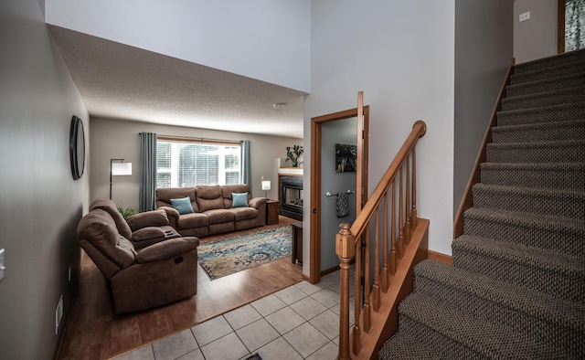 15608 Fjord Ave, Apple Valley, MN 55124 - living area featuring a fireplace, stairway, and light tile patterned floors