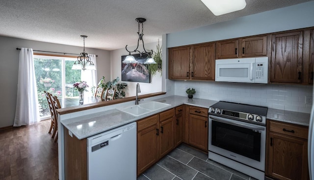 15608 Fjord Ave, Apple Valley, MN 55124 - kitchen featuring white appliances, a sink, a peninsula, decorative backsplash, and a textured ceiling