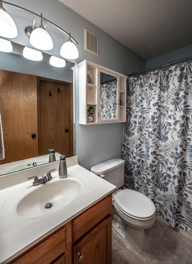 15608 Fjord Ave, Apple Valley, MN 55124 - bathroom featuring vanity, a textured ceiling, toilet, tile patterned floors, and a shower with shower curtain