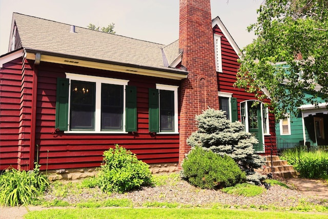145 Robie St W, Saint Paul, MN 55107 - view of home's exterior featuring a chimney and a shingled roof